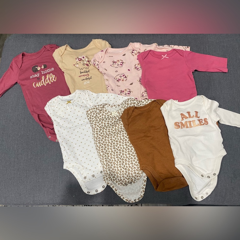 8 long sleeved onesies. Sizes 0-3 and 3-6